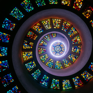 brown wooden spiral staircase with black metal railings